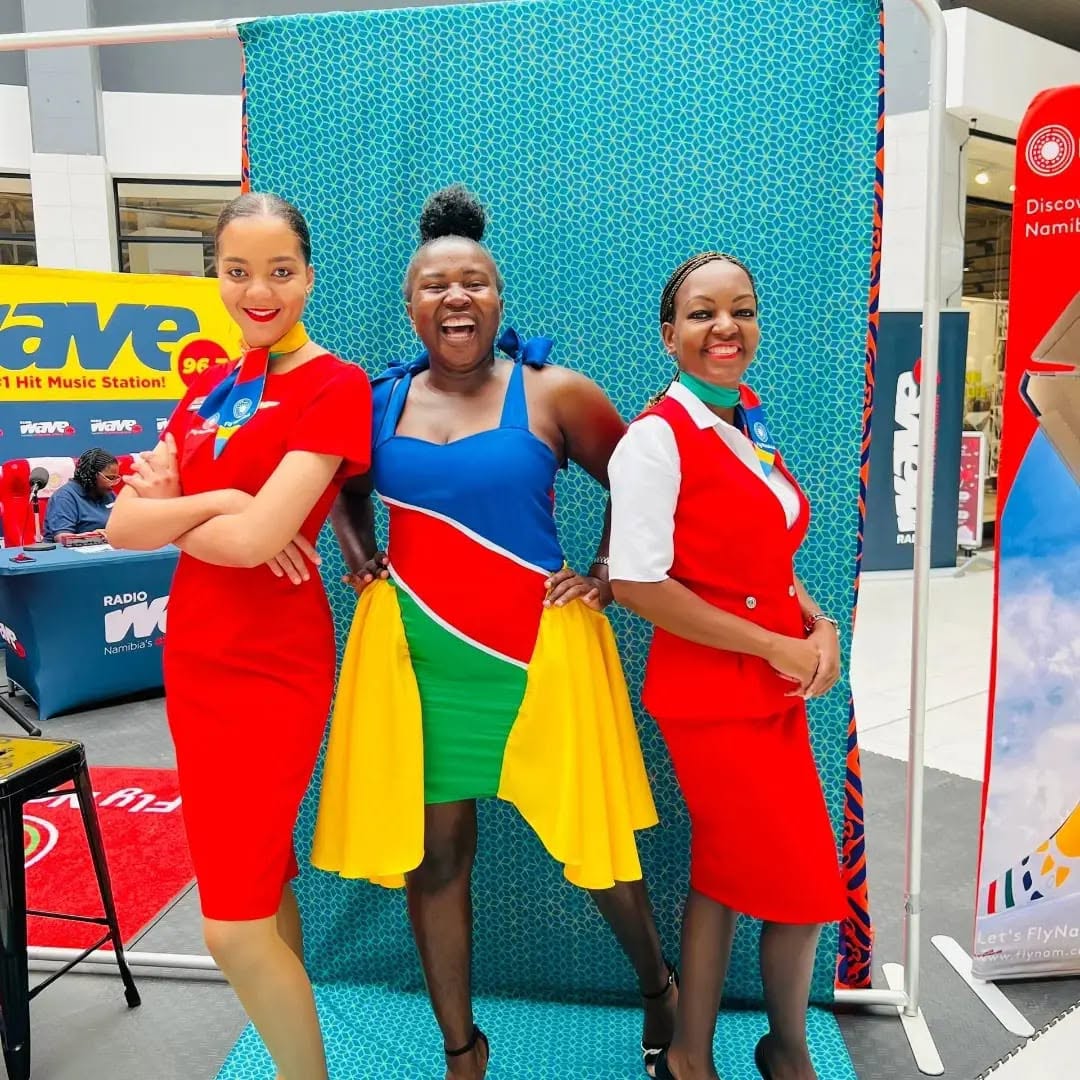 Jessica in FlyNamibia uniform with two women at an aviation promotional event